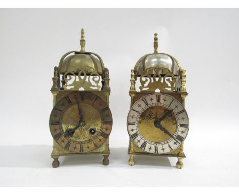 Two brass lantern clocks, one marked Elliot London. Both with engaged face, Roman numerals and pierced fish form fretwork, al