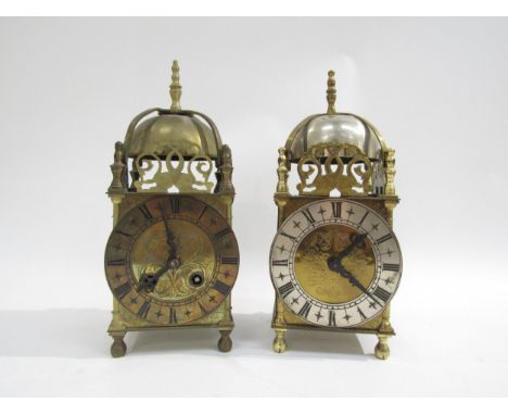 Two brass lantern clocks, one marked Elliot London. Both with engaged face, Roman numerals and pierced fish form fretwork, al