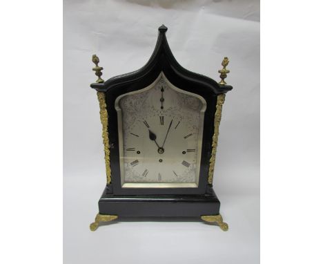 An 18th Century English ebonised bracket clock with cast brass feet, finials and side fret panels, silvered Roman dial, three