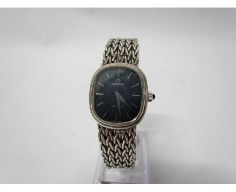 An Omega De Ville manual wind wristwatch, black face, rounded case 
