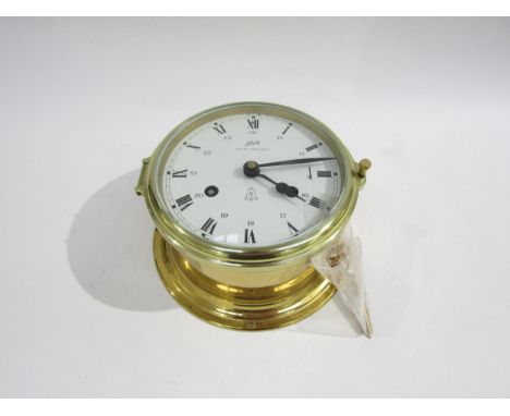 A Schatz royal mariner bulkhead brass clock white dial with Roman numerals and interior 24-hour numerals, with key. 13cm diam