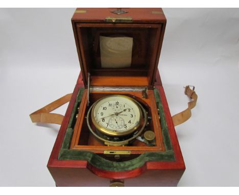 An early 20th Century Russian marine chronometer with silvered Arabic dial and twin subsidiary dials, mounted on a brass gimb