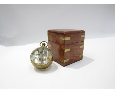 A magnifying spherical paperweight clock with visible movement from both sides, held with brass, Roman numeral dial, with box