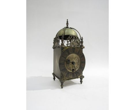 A brass lantern clock marked Coventry Astral, made in England, engraved dial with Roman numerals and pierced fish form fretwo