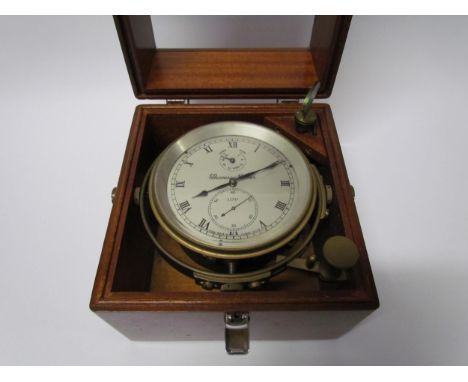 An early 20th Century marine chronometer by Thomas Mercer Ltd. , silvered Roman dial in brass gimbal frame and mahogany glaze