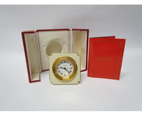 A Cartier alarm clock, cream and gilt brass, boxed with instructions. 7cm tall 