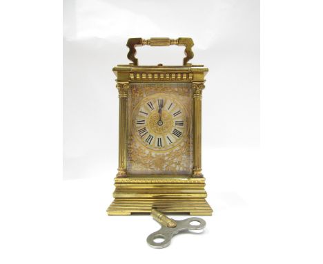 A 19th Century striking and repeating carriage clock in architectural brass column case, silvered Roman dial with pierced flo