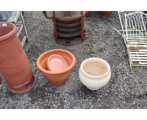 A terracotta planter together with one other