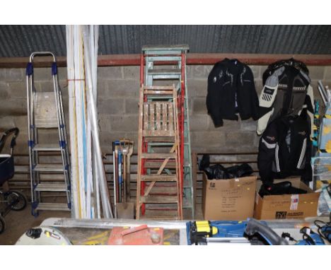 A wooden step ladder together with another wooden step ladder and a metal step ladder
