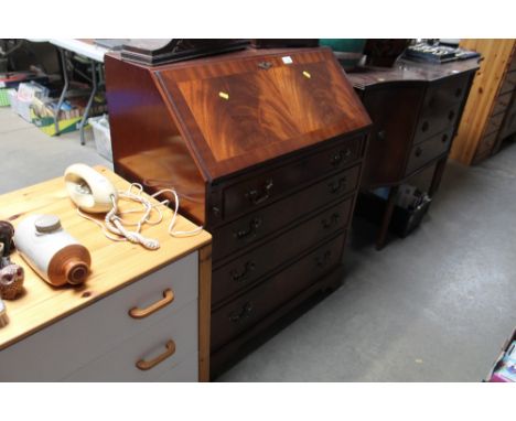 A reproduction mahogany bureau fitted four drawers