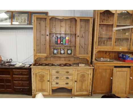 A stripped pine dresser raised on base fitted three central drawers flanked by cupboards AF