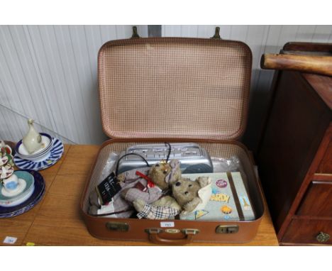 A case and contents to include box set Laurel and Hardy feature films, two teddy bears, portable radio cassette recorder