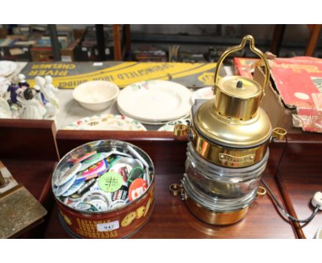 A tin of vintage buttons and a mast head lamp