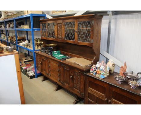 An Old Charm style dresser raised on base fitted four central drawers flanked by cupboards