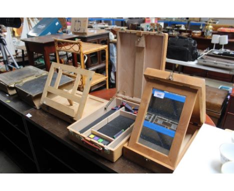 An artist easel and two artist boxes