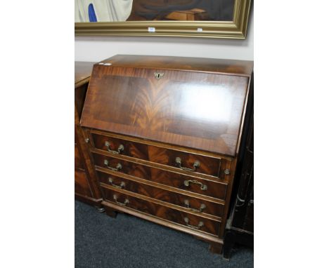 A mahogany Regency style writing bureau on bracket feet 