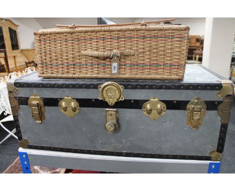 A mid 20th century metal trunk and a vintage picnic basket 