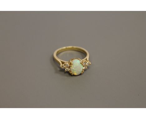 An 18ct gold opal and diamond ring, size M CONDITION REPORT: The ring is in good condition. It is hallamarked for the year 20