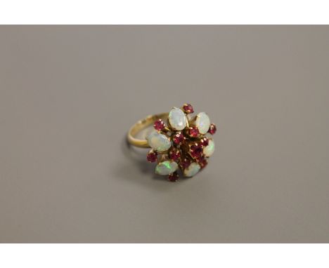 An 18ct gold opal and ruby cluster ring, size O/P