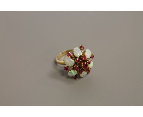 An 18ct gold opal and ruby cluster ring, size O/P