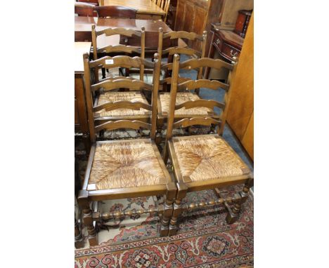 A set of four oak rush seated ladder backed dining chairs 