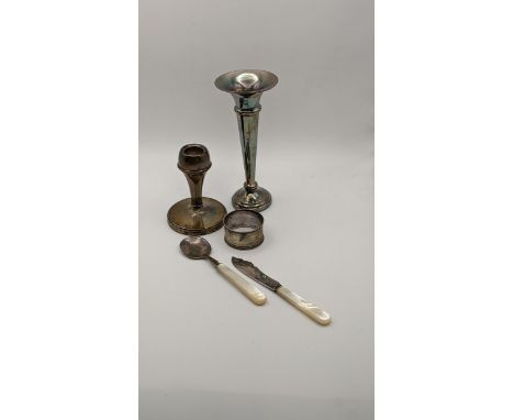 Mixed silver to include a Mother of Pearl and silver knife and spoon, a napkin ring, vase and candlestick holdersLocation: 