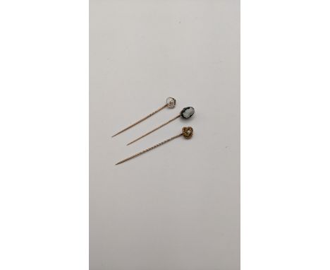 Three yellow metal stick pins to include a cameo stick pin, total weight 4.9gLocation: 