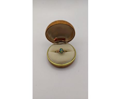 A 9ct gold ring set with an oval shaped opal, 1.9gLocation: 