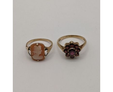 A 9ct gold ring set with red garnets fashioned as a flower 3g along with a yellow metal cameo ring, 1.9gLocation: 