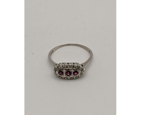 A 18ct white gold ring set with three rubies and diamonds 3gLocation: 