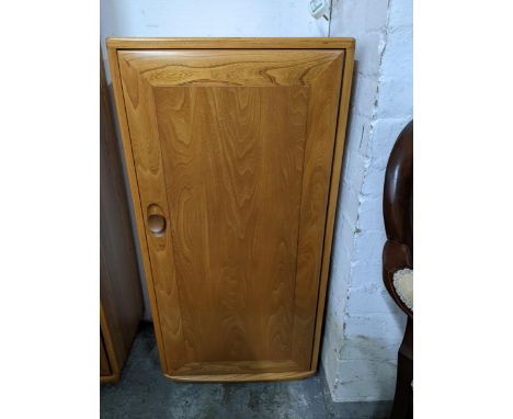 An Ercol Windsor style cabinet with three internal shelves, on short base 99cm x 46.5cm x 31.5cm Location: 