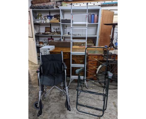 A DeVilbiss healthcare Drive folding wheelchair, a green tubular and plastic folding garden chair, no cushions, and a folding