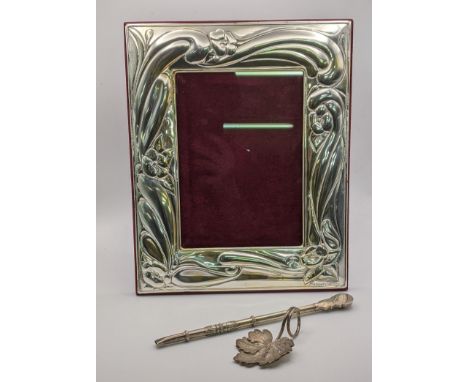 A silver embossed photo frame, a silver caddy spoon together with a silver yerba mate bombilla strawLocation: 