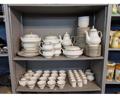 A Royal Doulton 'Gala Lace' pattern dinner service to include tow meat plates, two teapots, serving dishes, dinner plates, si