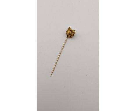 A yellow metal stick pin fashioned as foxes head inset with ruby eyes 7.5gLocation: 