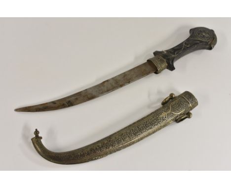 A Moroccan jambiya, 23.5cm curved blade, hardwood grip inlaid with silvered wire, chased scabbard, 41cm long overall