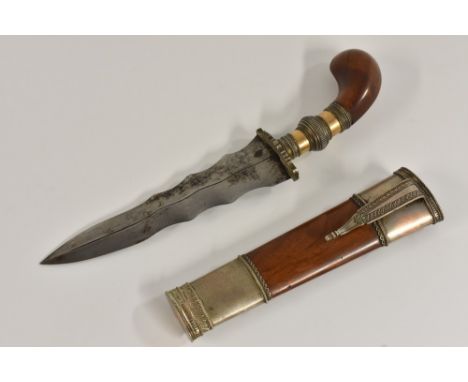 A Philippine gunong or punyal kris knife, 13.5cm wavy lade, white metal-muonted wooden gilt and scabbard, 23cm long overall, 