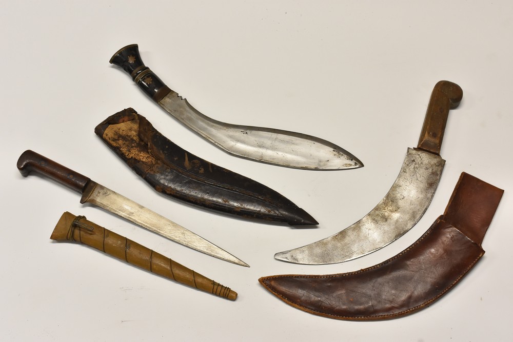 A curved fighting knife, stamped WCC, brown leather military type