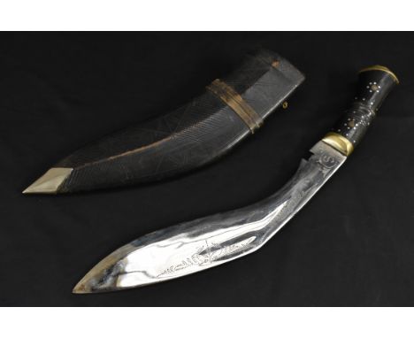 A Nepalese/Indian kukri, 29.5cm blade, horn grip inlaid with pin work, brass lion mask pommel, leather scabbard, 42cm long ov