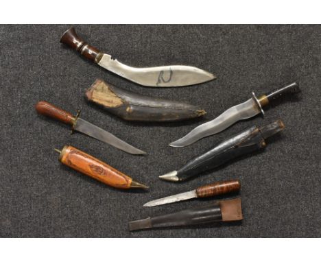 A Nepalese dagger, wavy blade, carved horn handle, leather scabbard; a kukri; an Indian Bowie knife; a Norwegian fisherman's 