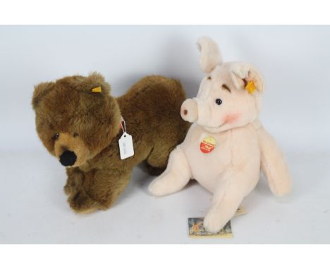 Steiff - Two Steiff plush toys. Lot includes Steiff #0343/25 'Molly' Brown Bear Cub 25cms (H); together with #056963 'The Pig