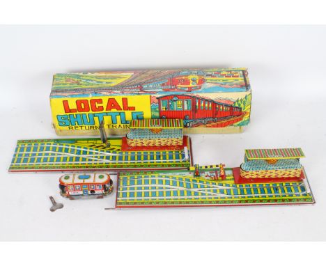 Hec - Agrawal - A boxed tin plate clockwork Local Shuttle Train with a two part track with Deli Station on it. The track appe