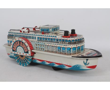 Modern Toys - An unboxed vintage tinplate battery powered Queen River boat. The model appears in Very Good condition with onl
