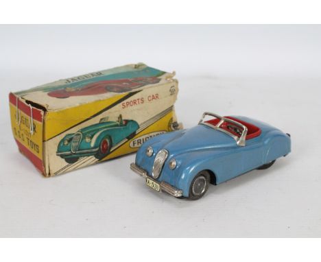 SSS - A boxed Jaguar XK120 vintage tinplate friction powered car. # A-531. The models is approximately 15 cm long and appears