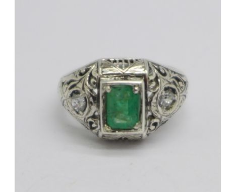 A white metal, emerald and diamond three stone ring, 4.2g, O, emerald approximately 7mm x 5mm 