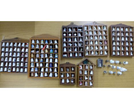 Over 200 collectors thimbles, mainly ceramic, with display racks **PLEASE NOTE THIS LOT IS NOT ELIGIBLE FOR POSTING AND PACKI