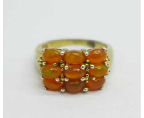 A silver gilt and fire opal ring, L 