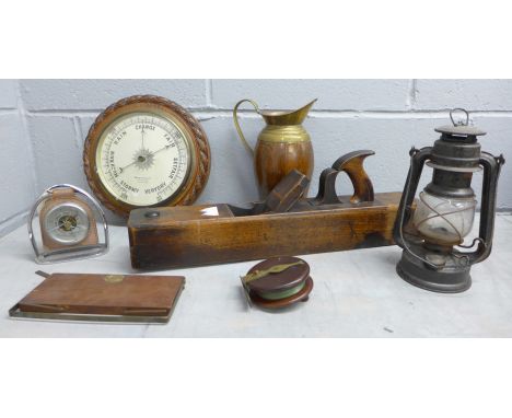 A wooden barometer, a horseshoe barometer, glass a/f,  a lantern, a fishing reel, a wood plane, a brass and wooden jug and a 