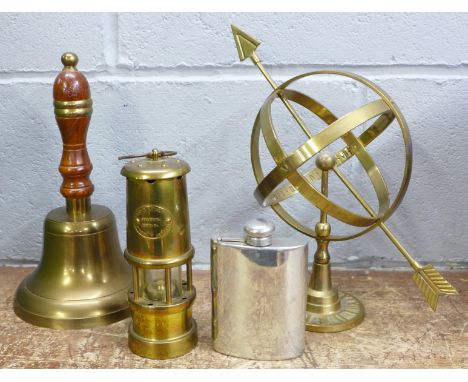 A brass hand bell, a small miner's lamp, an armillary and a pewter spirit flask 