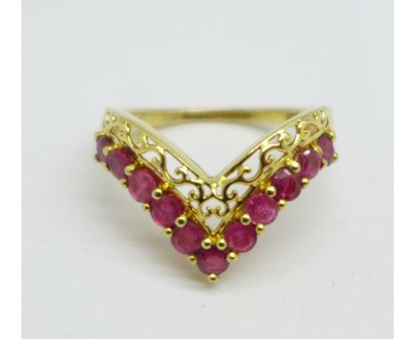 A silver gilt ring set with red stones, O 